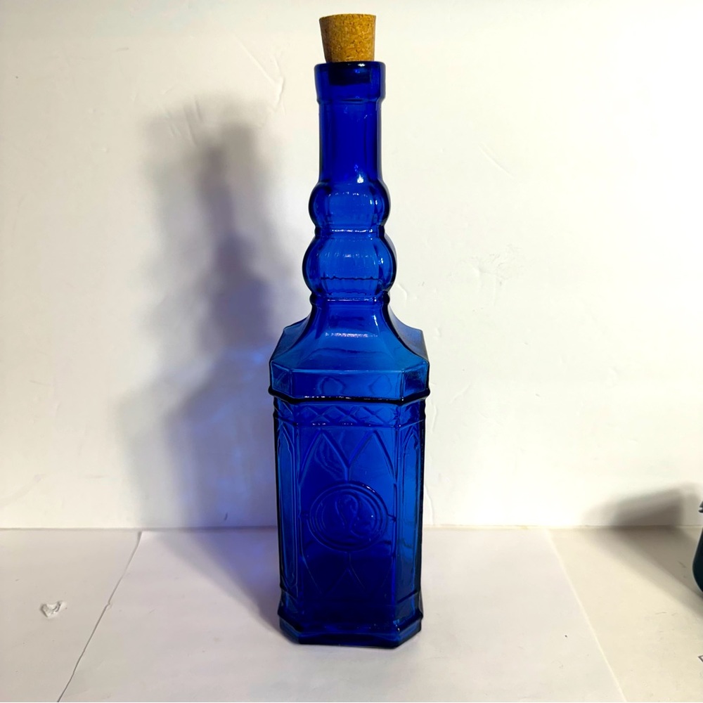 Cobalt Blue glass decorative bottle with cork. Approx. 11 3/4" Ornate Bottle